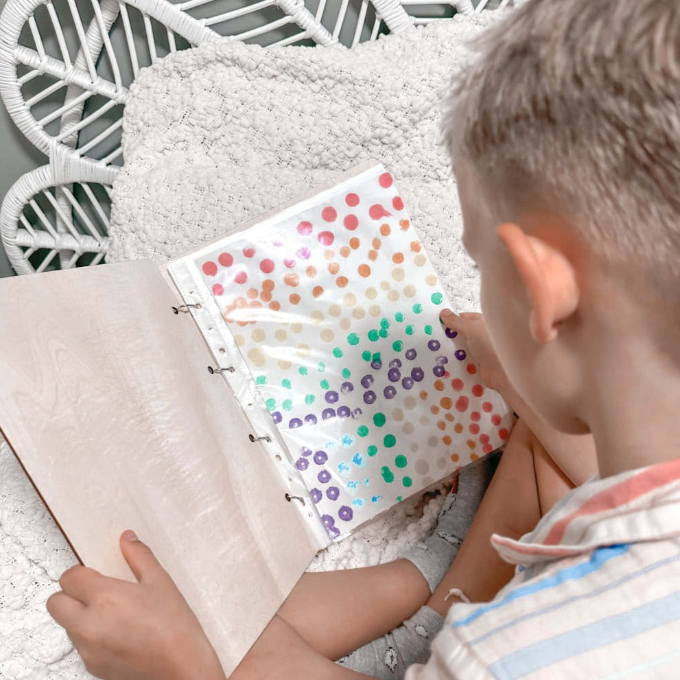 Open Weeping Willow children's art binder showing sleeve storage — holds up to 50 artworks