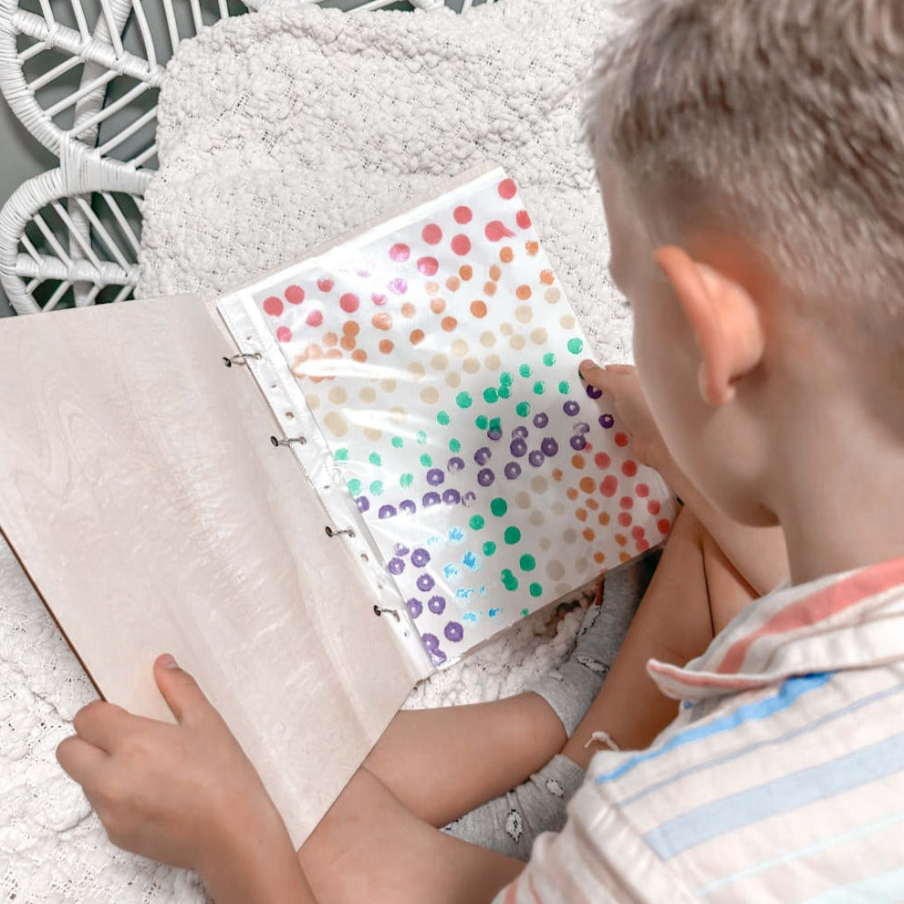ArtBinderopenwithsleeves.jpg	Open personalised children's art binder showing plastic sleeves — stores up to 50 artworks