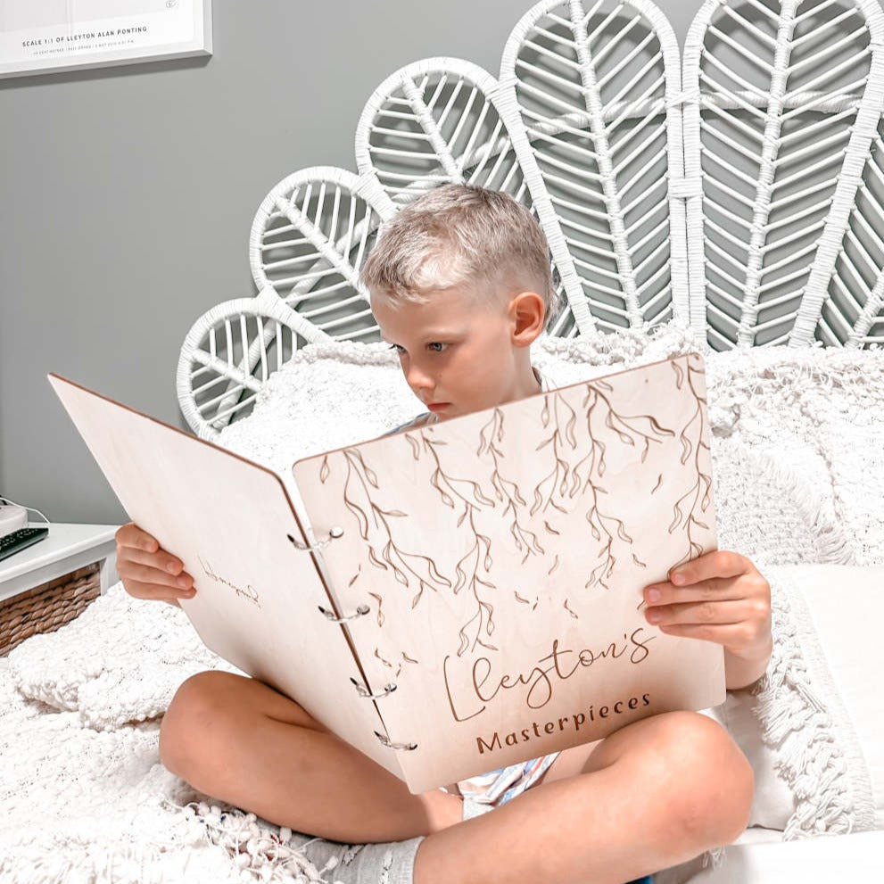 Boy holding his personalised Weeping Willow art binder — children's artwork folder Australia