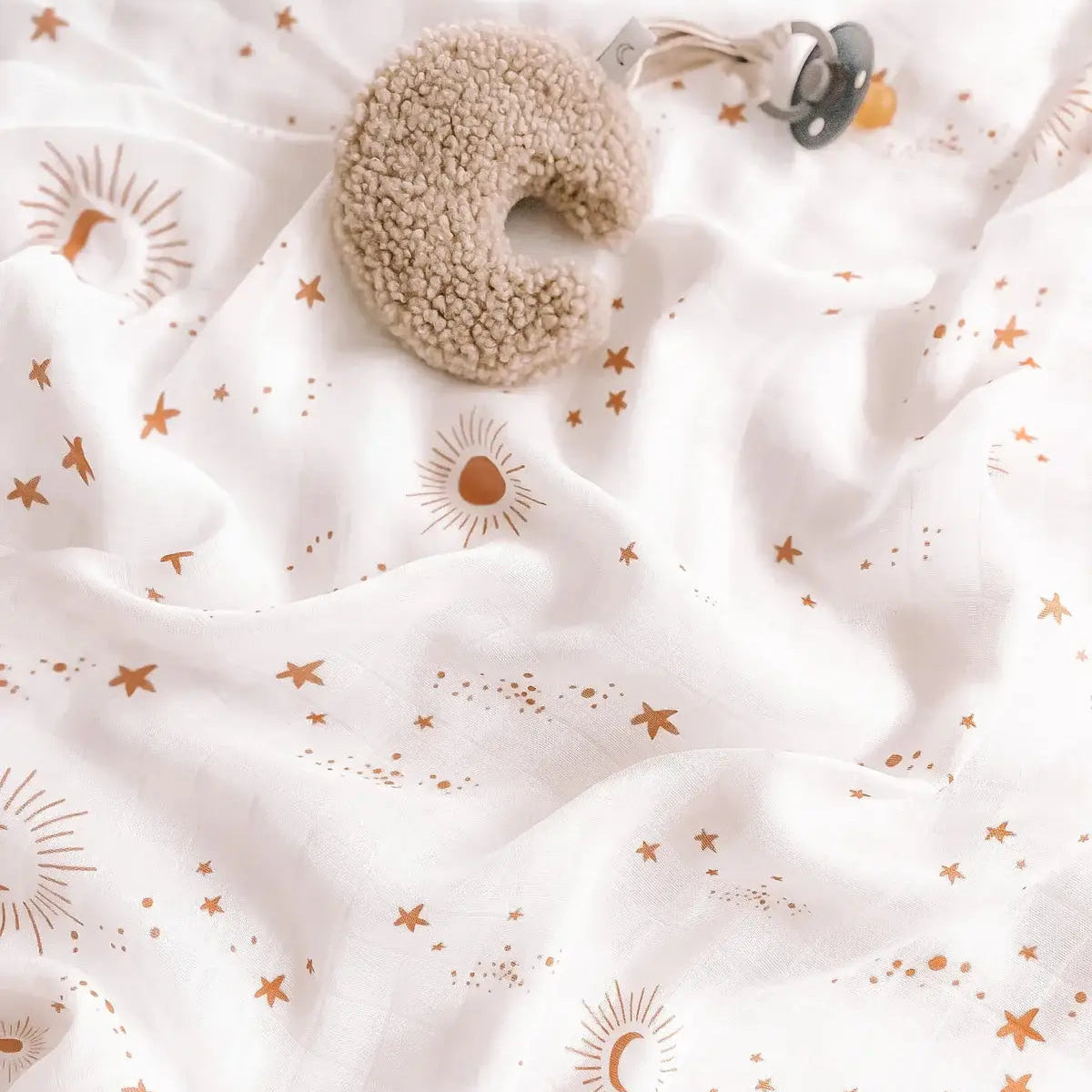 Close up of soft organic bamboo cotton swaddle fabric in the Constellation star and moon print
