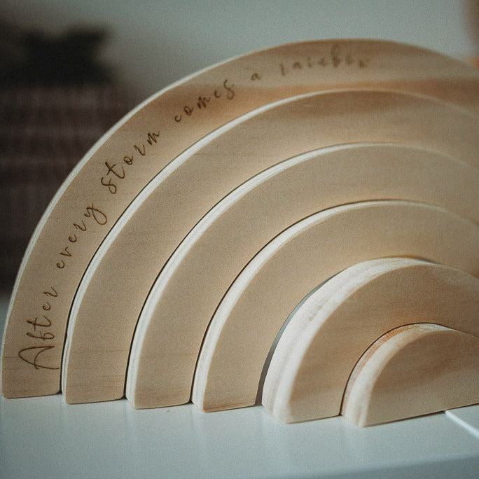 Quote rainbow lifestyle shot — personalised wooden rainbow with engraved quote for nursery