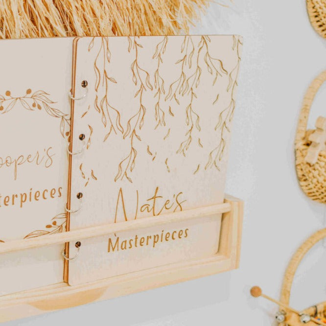 Olive Leaf and Weeping Willow children's art binders side by side — personalised keepsake options