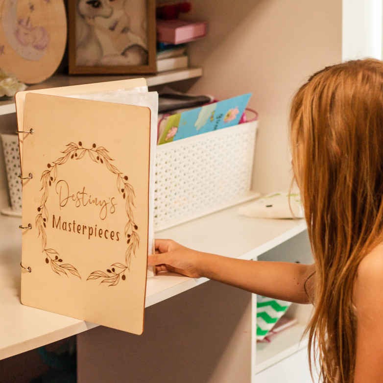 Destiny with her personalised Olive Leaf art binder — children's artwork storage, Honeycomb Living
